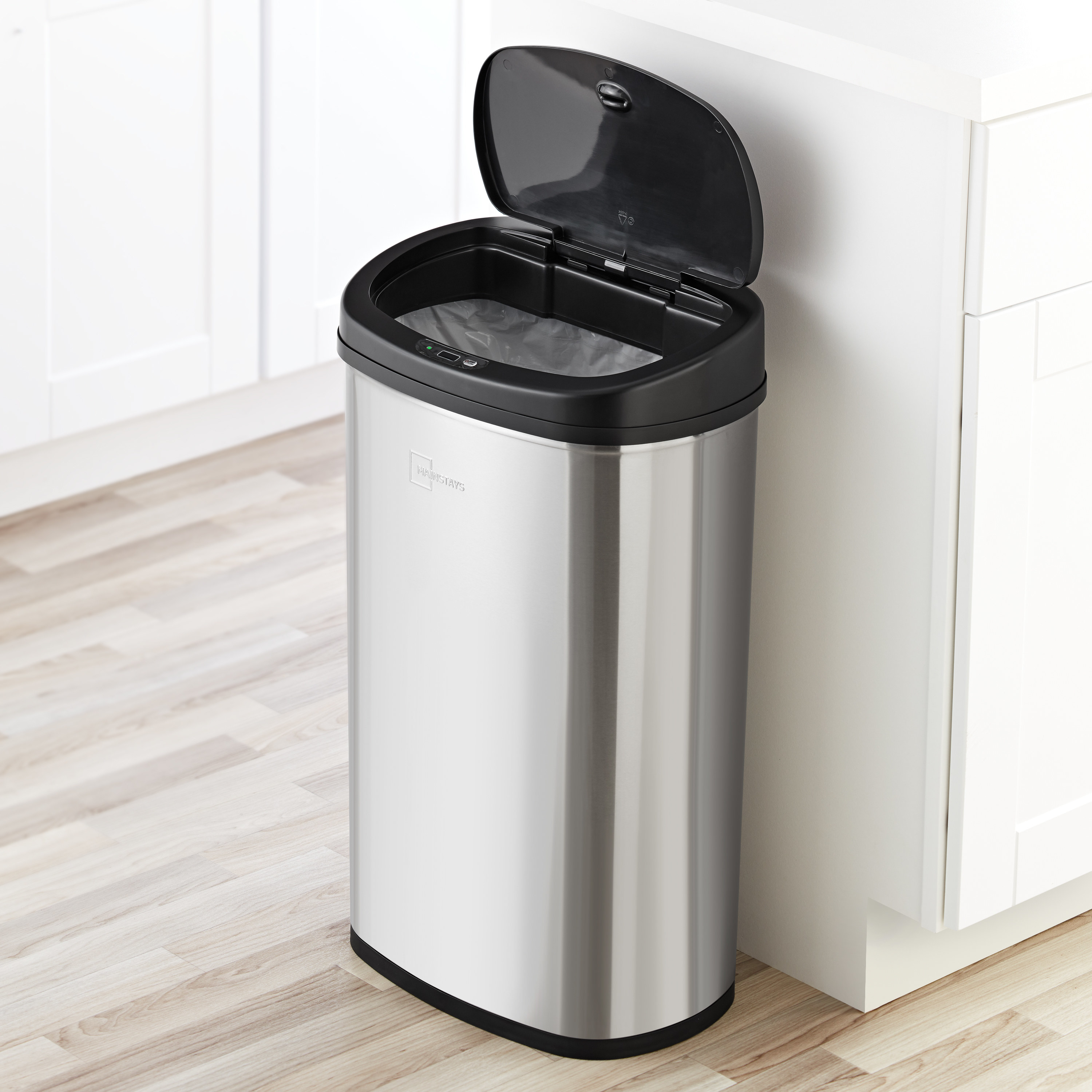 stainless steel motion activated trash can with the lid up in a kitchen
