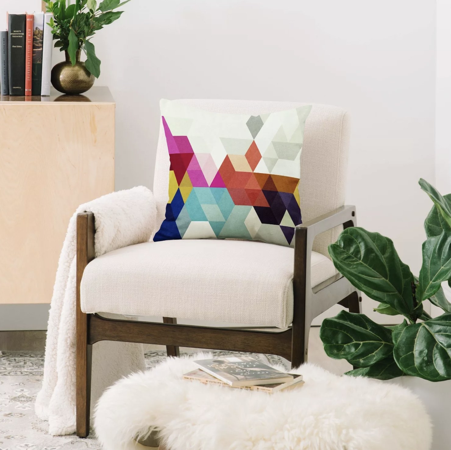 A geometric patterned throw pillow on a chair in a living room