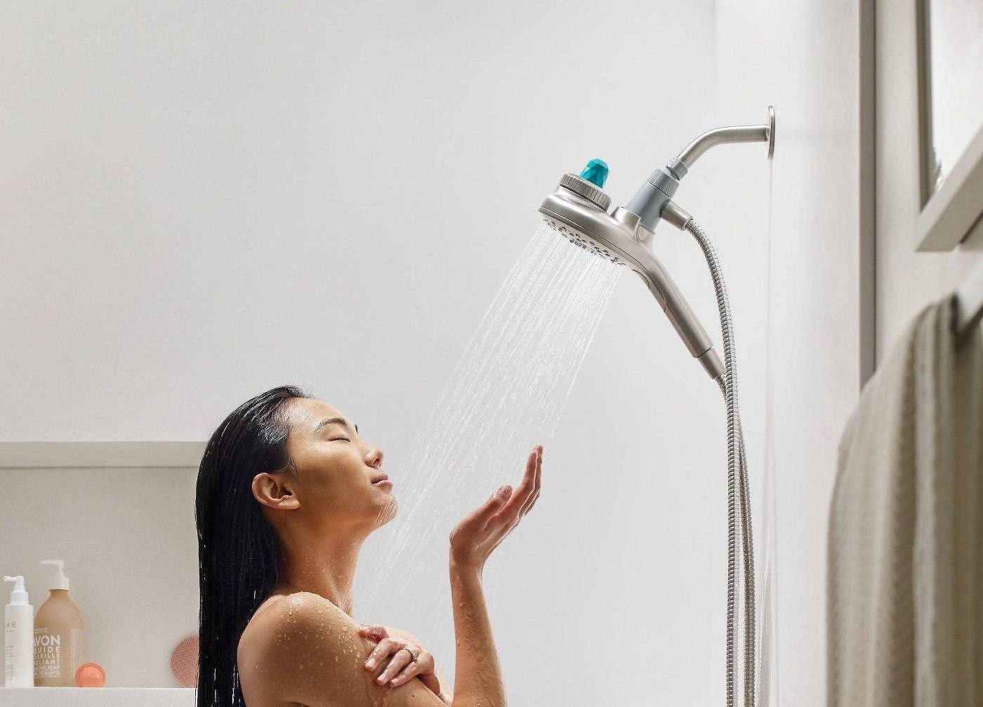 The brushed nickel shower head with a blue fragrance capsule