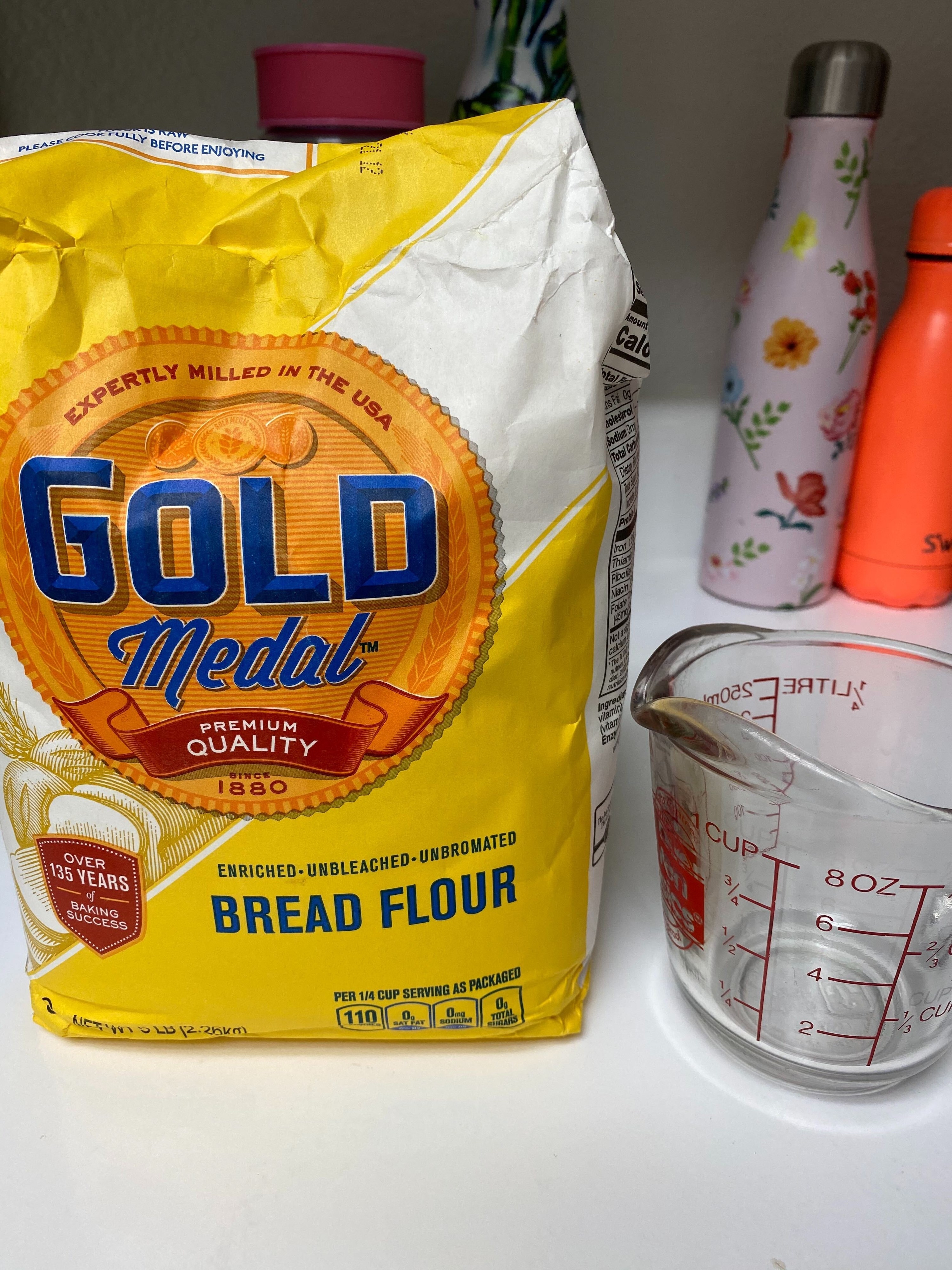 5 lb. bag of bread flour next to 8 oz. measuring cup