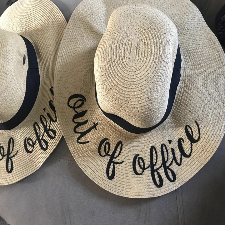 Reviewer image of straw hat with "out of office" embroidered on the brim 