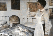 gif of julie andrews as mary poppins snapping her fingers to fold shirts and fly them into a drawer to the astonishment of jane and michael
