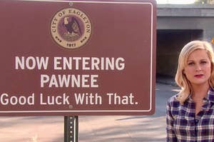 Leslie Knope next to a Now Entering Pawnee sign that says "Good luck with that."