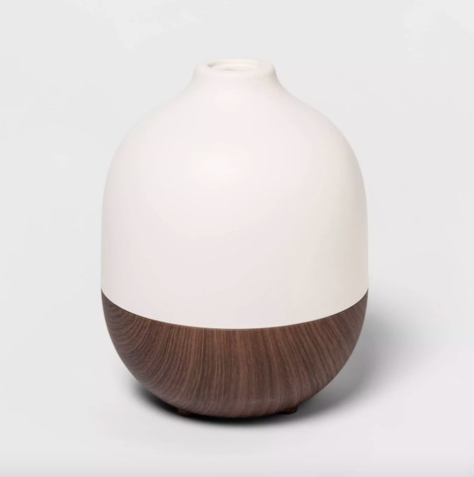 The teardrop-shaped diffuser, with a wood-grain bottom and a white top