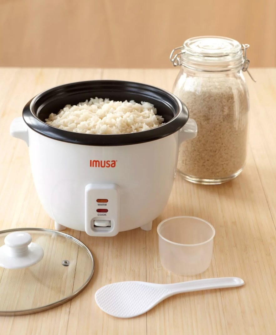 The rice cooker being used to cook white rice