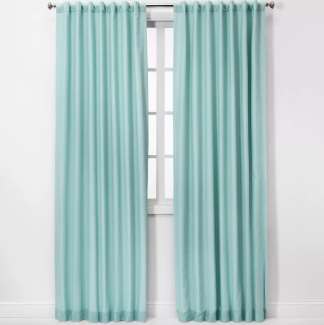 Two long blackout curtain panels in light blue