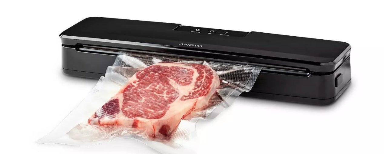 The vacuum sealer being used to seal a raw steak