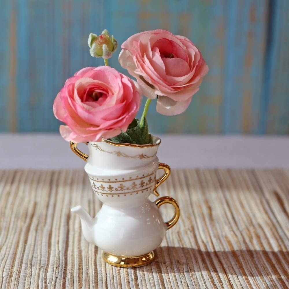 A vase that&#x27;s shaped like two tea cups on top of a tea pot