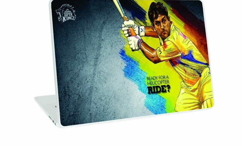 A laptop with a CSK skin that has an image on MS Dhoni and text that says &quot;Ready for a helicopter ride?&quot; 