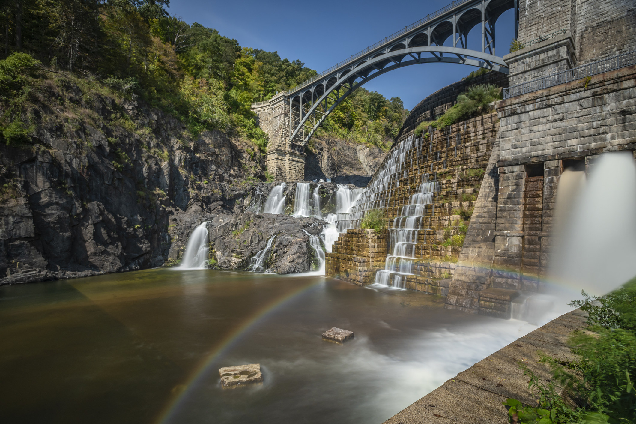 water flowing down rocks underneath a bridge in the New Croton Reservoir