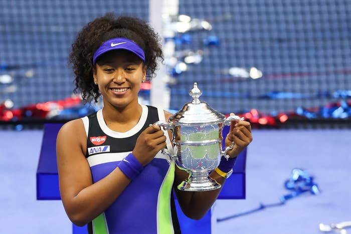 Naomi holding her third Grand Slam trophy at the US Open