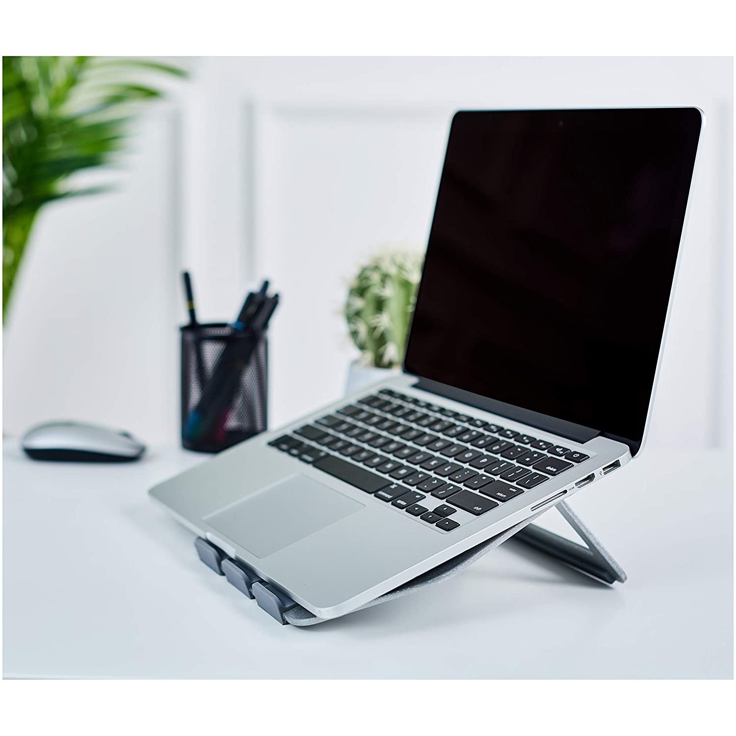 A laptop placed on the silver laptop stand