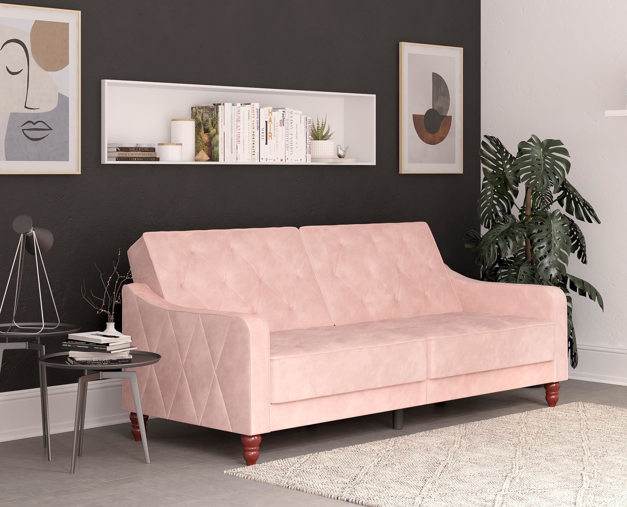 Pink velvet tufted couch with wooden legs