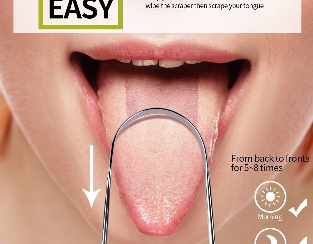 A person uses a tongue scraper to remove film on their tongue