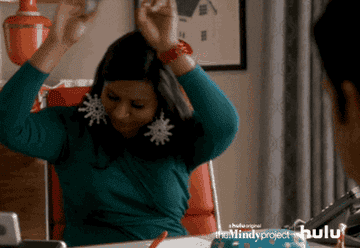 Mindy from The Mindy project does a happy dance in her desk chair