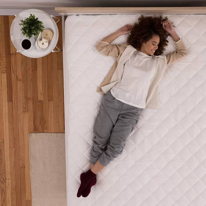 A model on a quilted mattress pad
