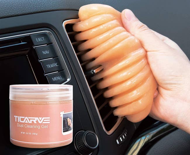 The TICARVE Dust Cleaning Gel removing dust from a car's air vent. 