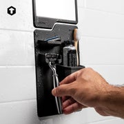 A person removes their razor from the shower organizer