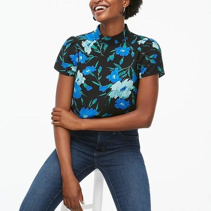 Model in the green floral and blue floral mock neck top