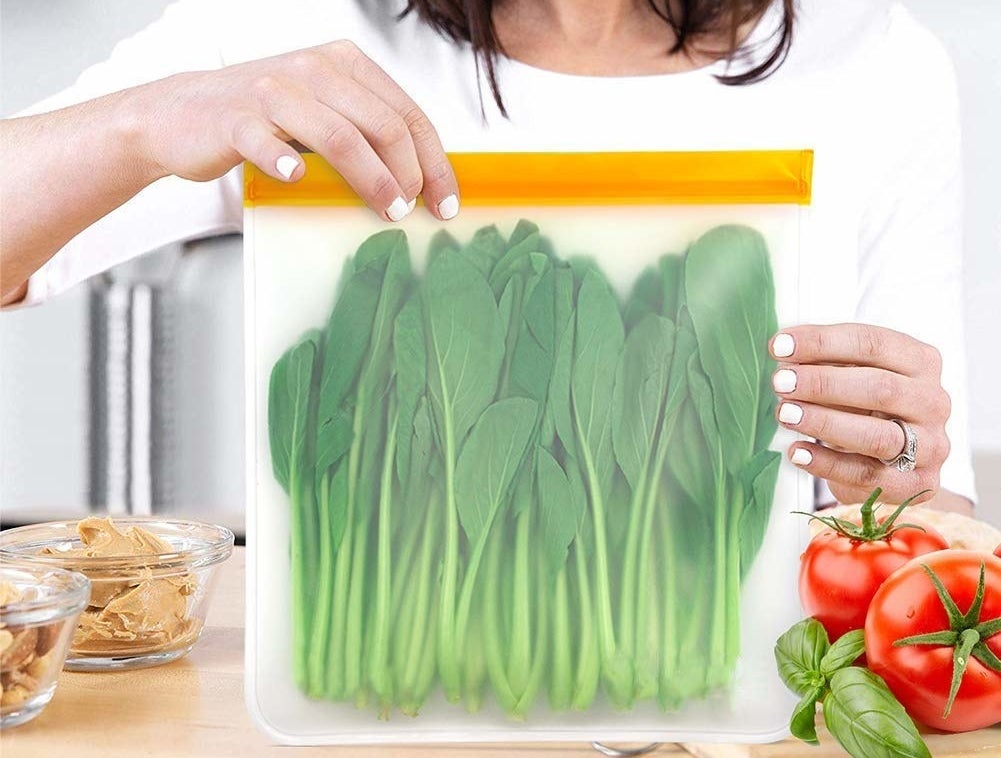 Greens inside a plastic bag being held by a person