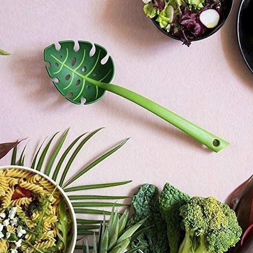 The leaf-shaped slotted spoon next to bowls of pasta and salads