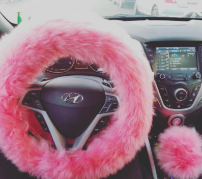 reviewer pic of pink faux fur steering wheel cover and matching gear stick