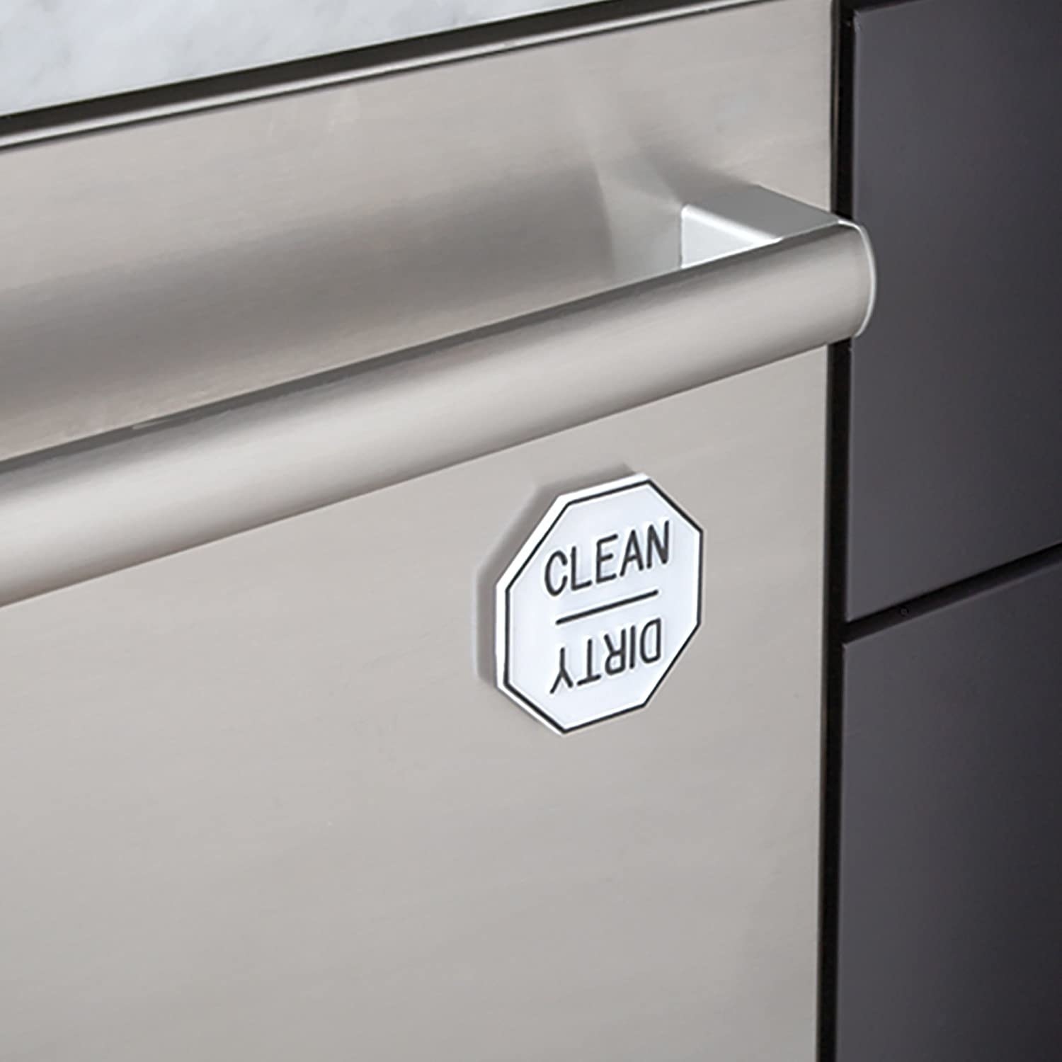 The magnet attached to the dishwasher, indicating that the dishes inside are clean