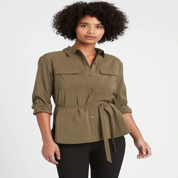 Model in the olive green tie-waist blouse