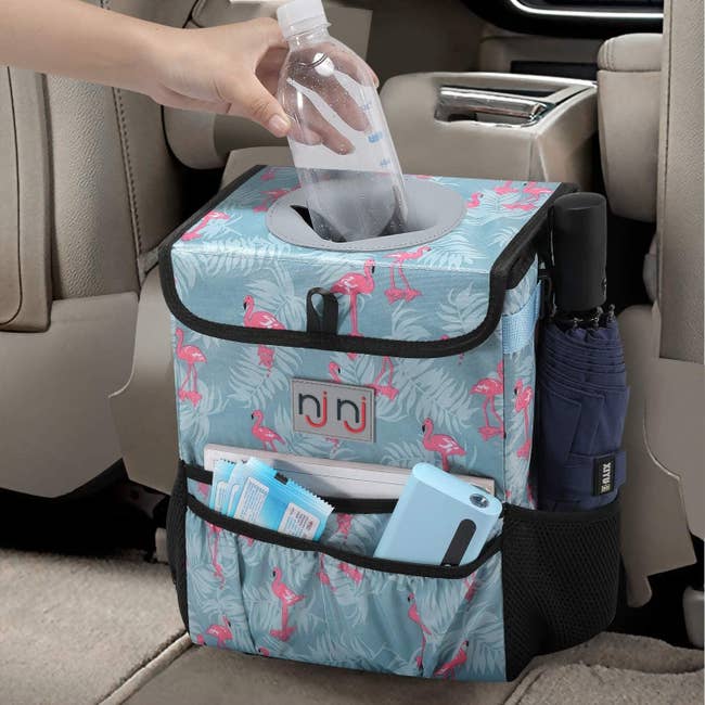 cube-shape car trash can in a flamingo print with storage pockets on the front and sides