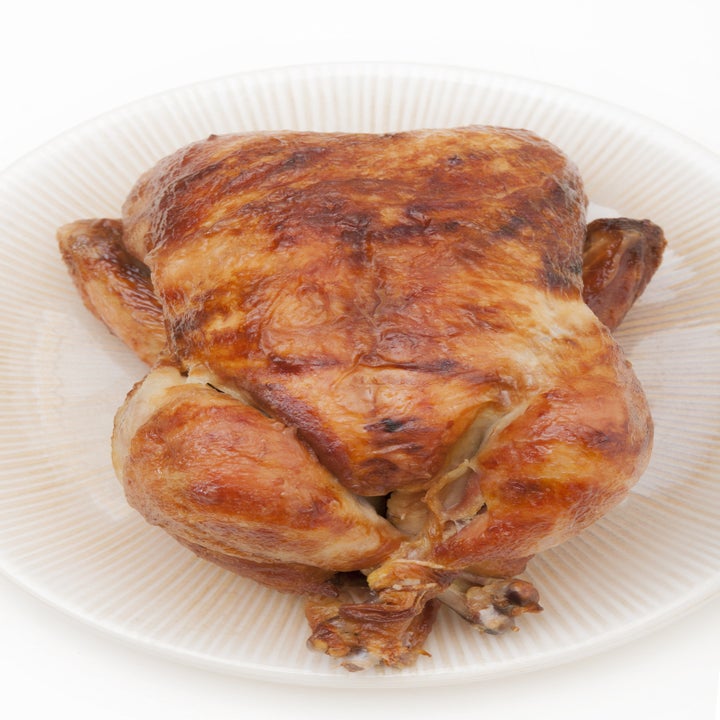 A rotisserie chicken on a plate.