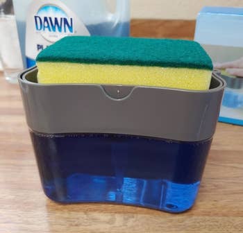 Reviewer pic of the sponge resting in the dispenser caddy