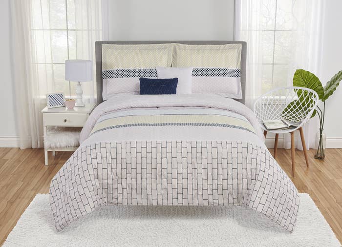 The white patterned duvet cover and pillowcases on a bed