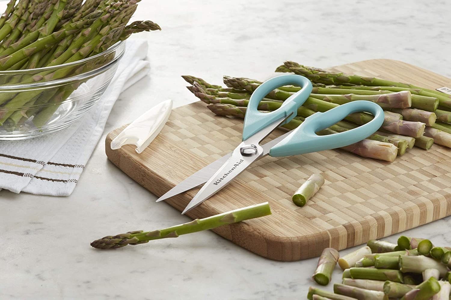 The kitchen shears next to some freshly chopped asparagus