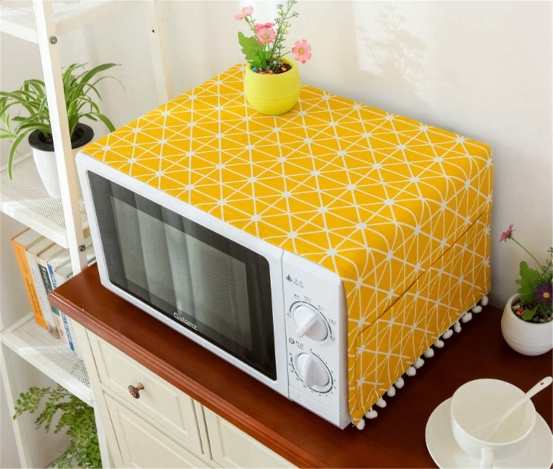 A bright cover on a microwave in a neat kitchen