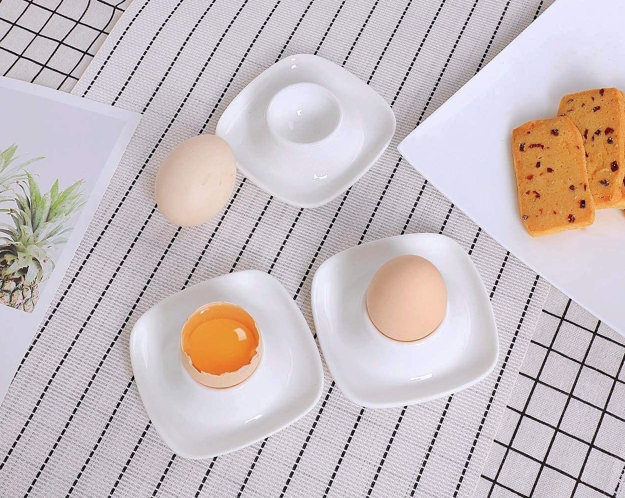 Three egg saucers arranged on a tablecloth