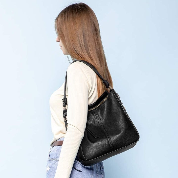 model carrying black bag 