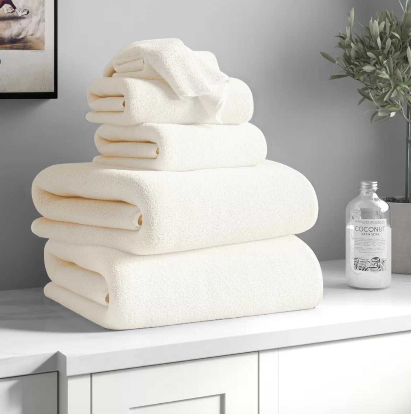 The white towel set stacked on the bathroom counter