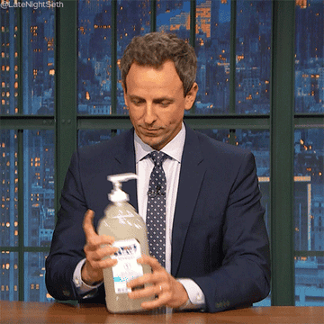 GIF of a man squirting hand sanitizer into his mouth