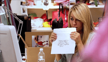 GIF of a woman licking an envelope