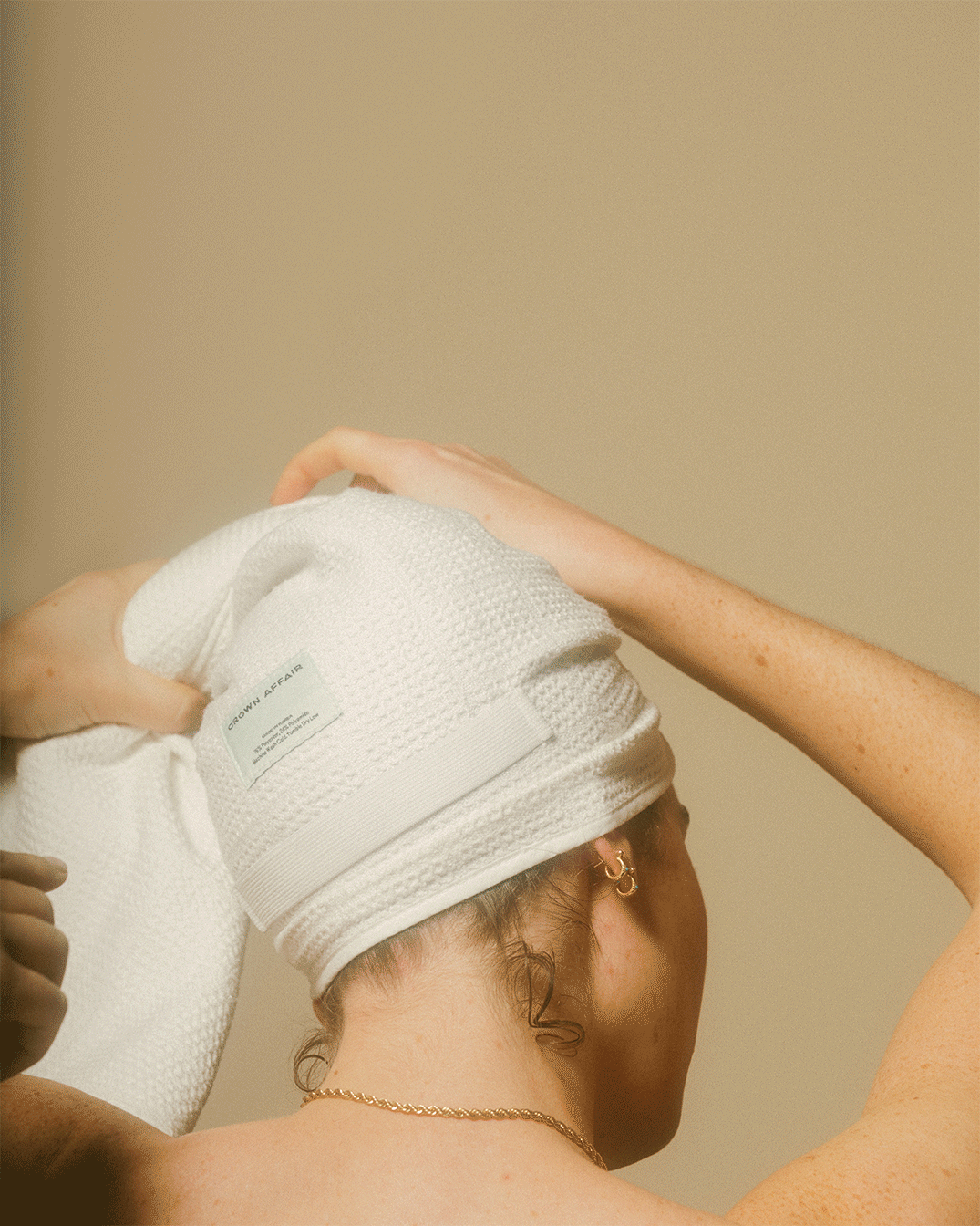 Gif of model tying their hair in the towel