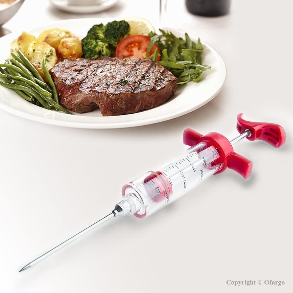 A syringe by a plate of dinner