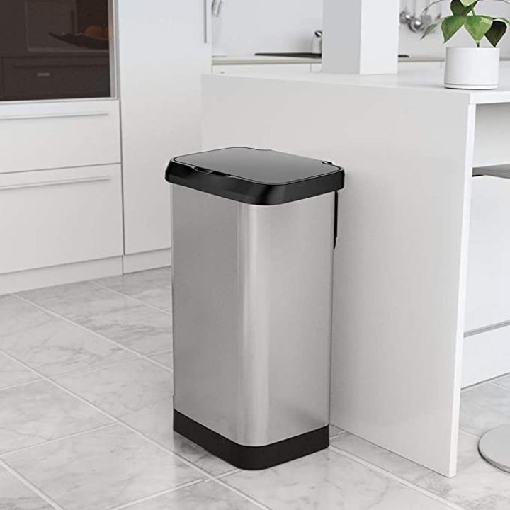 The GLAD Extra Capacity Stainless Steel Sensor Trash Can with Clorox Odor Protection in a kitchen