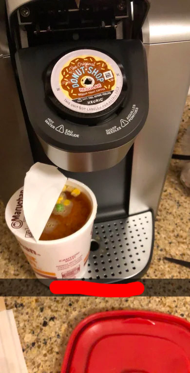 keurig with a coffee pod in it and a ramen noodles cup with brown water