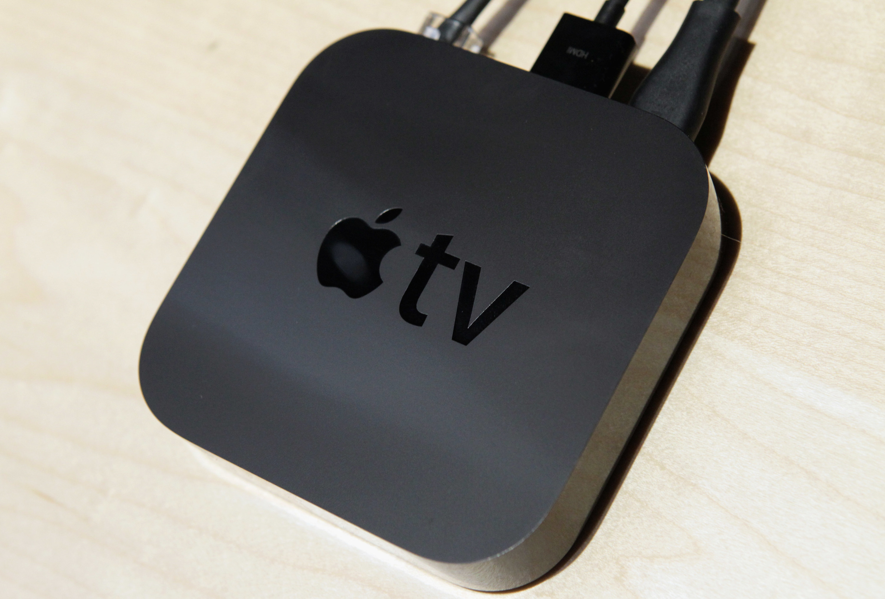 A photo of second generation Apple TV with wires attached to it