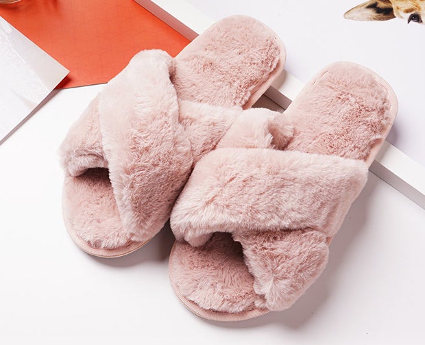 A pair of fuzzy slippers on a magazine
