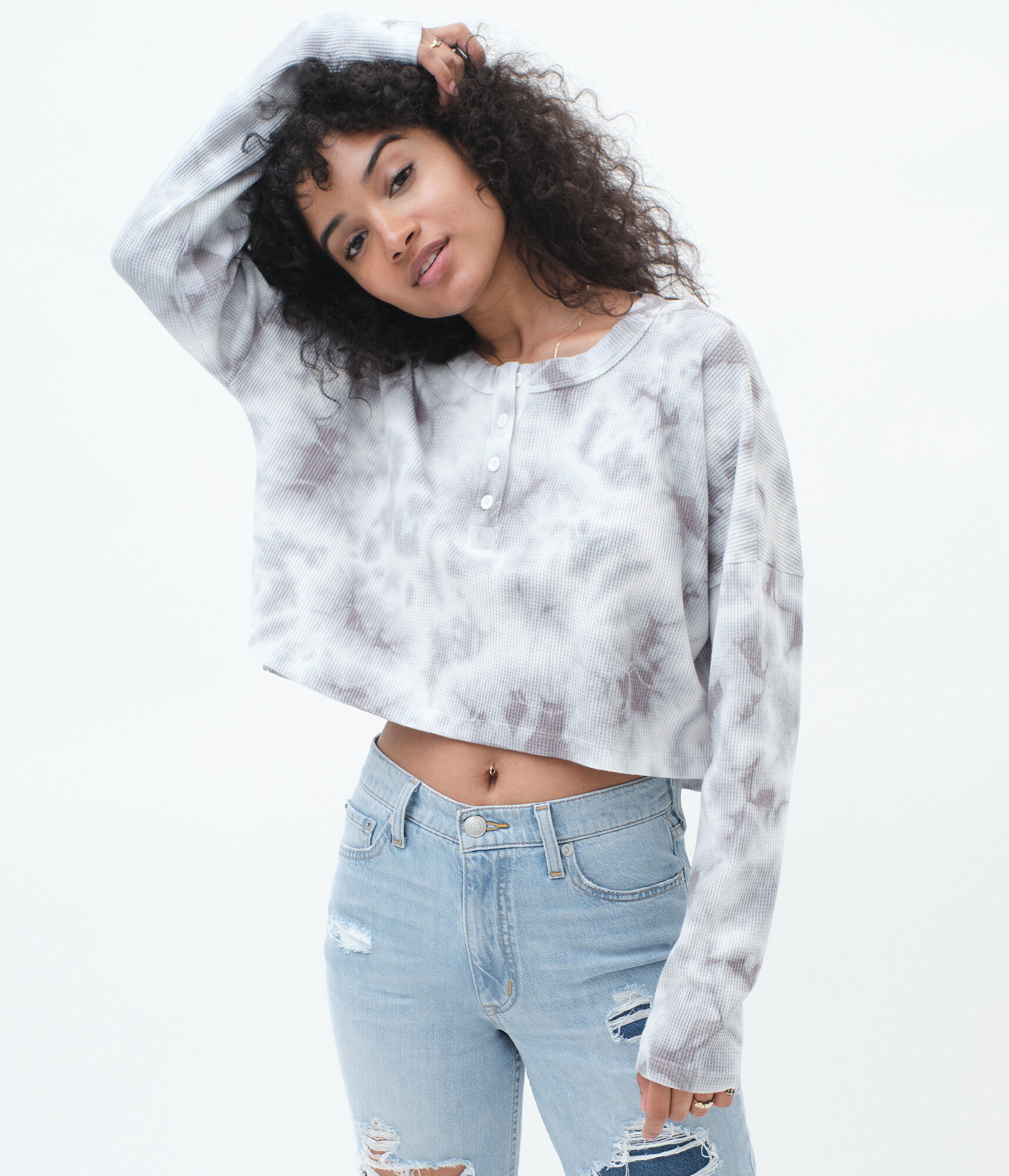 a model in the cream and grey long sleeve top