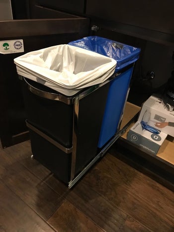 The simplehuman Dual Compartment Under Counter Kitchen Cabinet Pull-Out Recycling Bin and Trash Can installed under a customer's kitchen sink