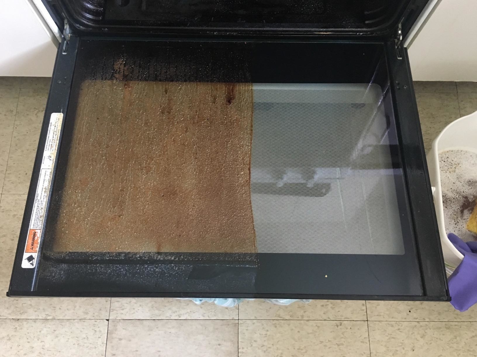 A customer&#x27;s oven door revealing caked on grime on one half of it and a clean surface on the other half