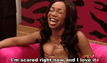 A gif of Tiffany Pollard sitting on a chair laughing and saying &quot;I&#x27;m scared right now and I love it&quot;