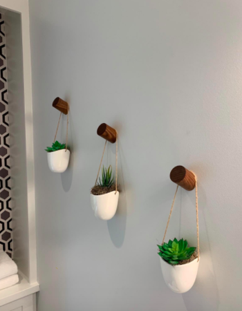 Reviewer uses same wall hooks to display hanging succulents on a corner wall